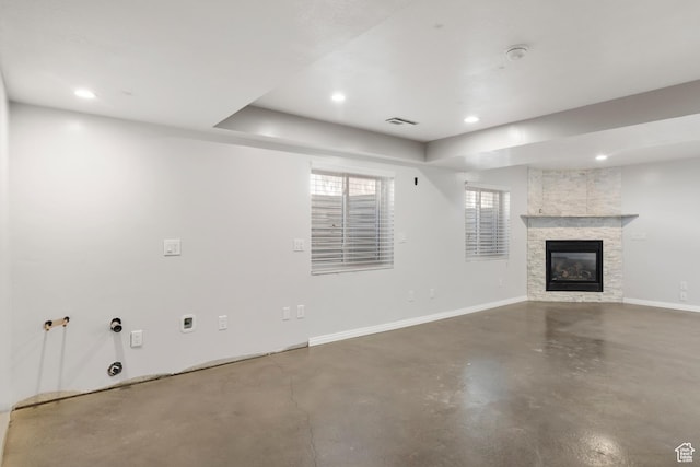 8793 S Mountain Vista Dr, West Jordan, UT 84081 - unfurnished living room with finished concrete floors, a stone fireplace, recessed lighting, and baseboards