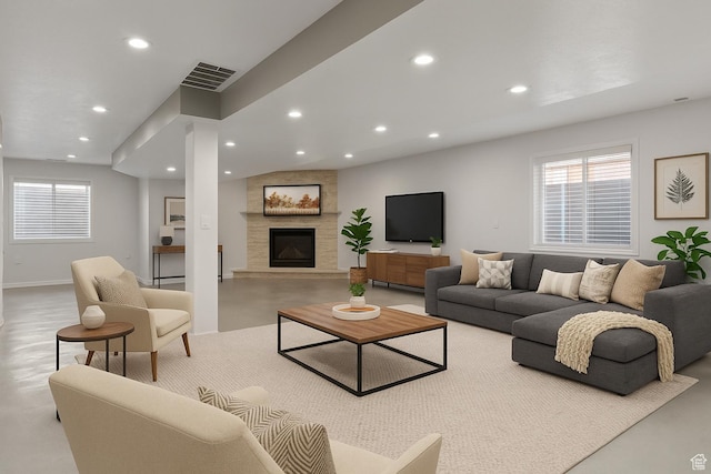8793 S Mountain Vista Dr, West Jordan, UT 84081 - living room with healthy amount of natural light, recessed lighting, a fireplace, concrete flooring, and baseboards