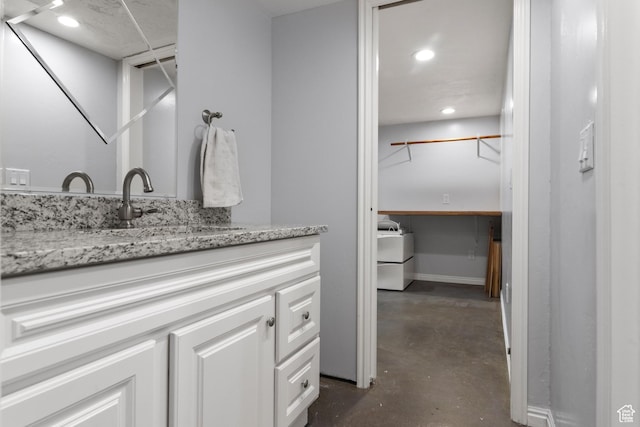 8793 S Mountain Vista Dr, West Jordan, UT 84081 - bathroom featuring concrete floors, vanity, and recessed lighting
