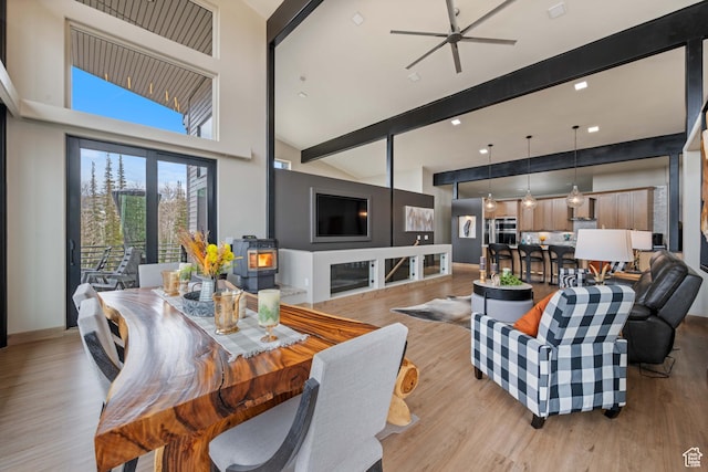466 N Elk Dr, Brian Head, UT 84719 - dining room featuring light wood-style floors, a wood stove, and a ceiling fan