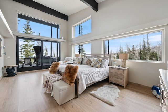 466 N Elk Dr, Brian Head, UT 84719 - bedroom featuring access to outside, beam ceiling, light wood-style floors, and a towering ceiling