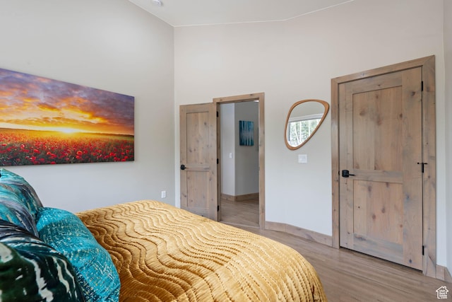 466 N Elk Dr, Brian Head, UT 84719 - bedroom featuring light wood finished floors, a high ceiling, and baseboards