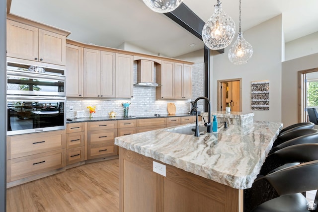 466 N Elk Dr, Brian Head, UT 84719 - kitchen featuring a sink, wall chimney exhaust hood, tasteful backsplash, lofted ceiling, and light brown cabinetry