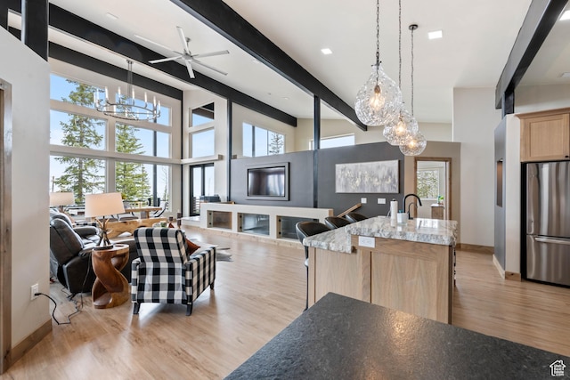 466 N Elk Dr, Brian Head, UT 84719 - living area featuring a chandelier, beamed ceiling, light wood-type flooring, and baseboards
