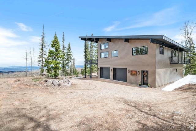 466 N Elk Dr, Brian Head, UT 84719 - view of side of property featuring a garage, dirt driveway, and a mountain view