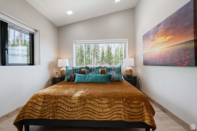 466 N Elk Dr, Brian Head, UT 84719 - bedroom with wood finished floors, lofted ceiling, multiple windows, and baseboards