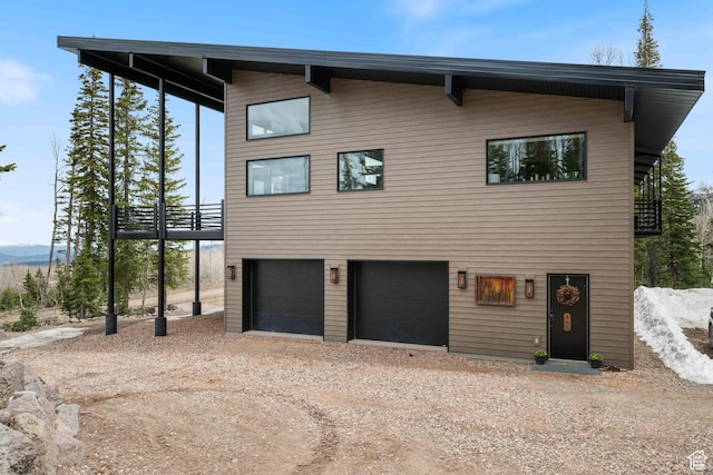 466 N Elk Dr, Brian Head, UT 84719 - view of front of home featuring driveway, a garage, and a balcony