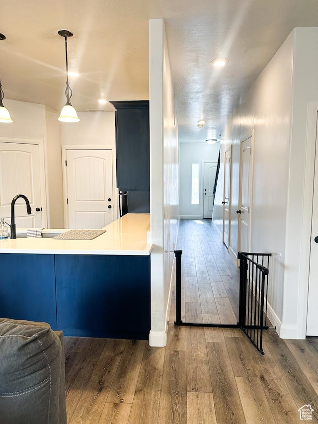 404 W 1325 N Unit L5, Cedar City, UT 84721 - kitchen featuring hardwood / wood-style flooring, pendant lighting, light countertops, and a peninsula