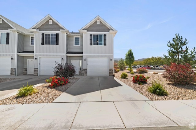 404 W 1325 N Unit L5, Cedar City, UT 84721 - view of front facade with stone siding, driveway, and a garage