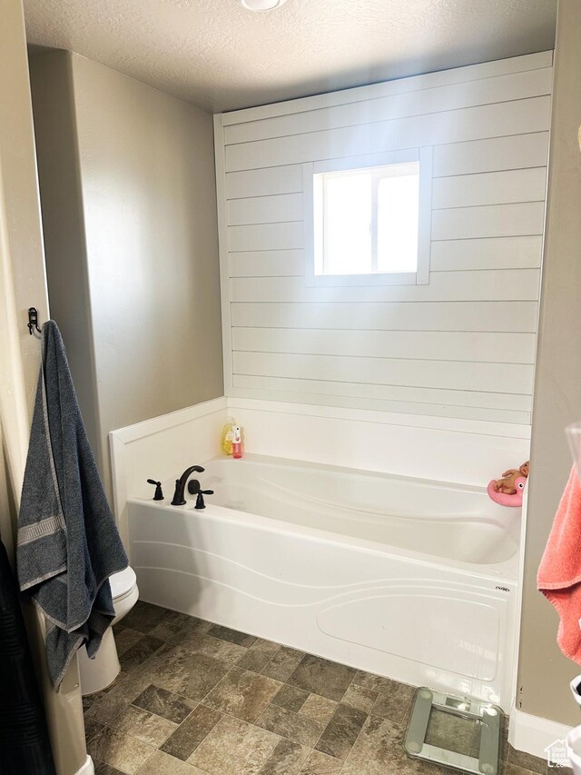 404 W 1325 N Unit L5, Cedar City, UT 84721 - full bath featuring a bath, a textured ceiling, and stone finish flooring