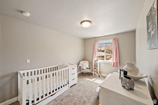 404 W 1325 N Unit L5, Cedar City, UT 84721 - carpeted bedroom with a textured ceiling, a nursery area, and baseboards