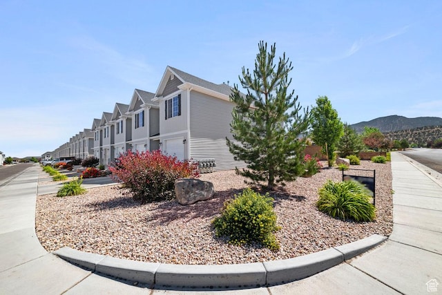 404 W 1325 N Unit L5, Cedar City, UT 84721 - view of property exterior featuring a garage, a residential view, and a mountain view