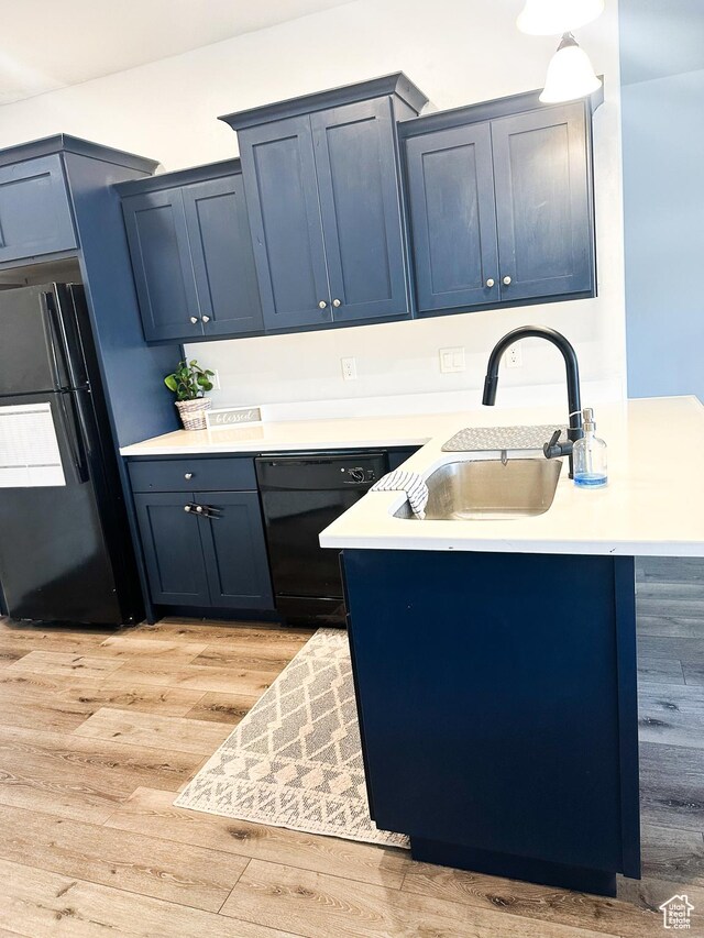 404 W 1325 N Unit L5, Cedar City, UT 84721 - kitchen with black appliances, light countertops, a peninsula, light wood finished floors, and blue cabinetry