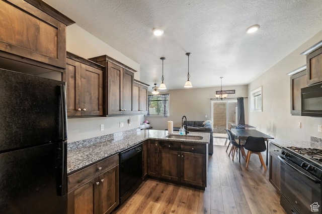404 W 1325 N Unit L5, Cedar City, UT 84721 - kitchen featuring black appliances, a sink, light stone countertops, dark brown cabinetry, and light wood-style floors