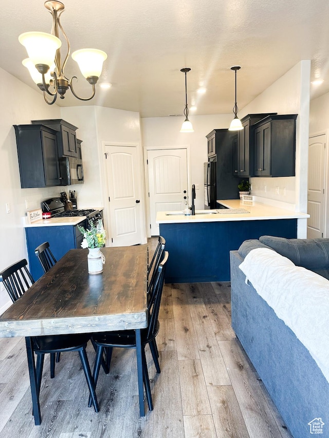 404 W 1325 N Unit L5, Cedar City, UT 84721 - dining area with light wood-type flooring and a chandelier