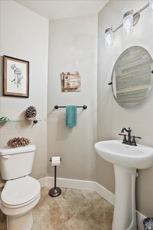 4548 N Sheep Creek Dr, Eden, UT 84310 - bathroom with baseboards, toilet, and a sink