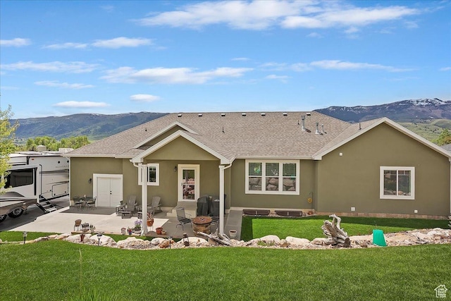 4548 N Sheep Creek Dr, Eden, UT 84310 - back of house featuring a mountain view, stucco siding, a patio area, and a yard