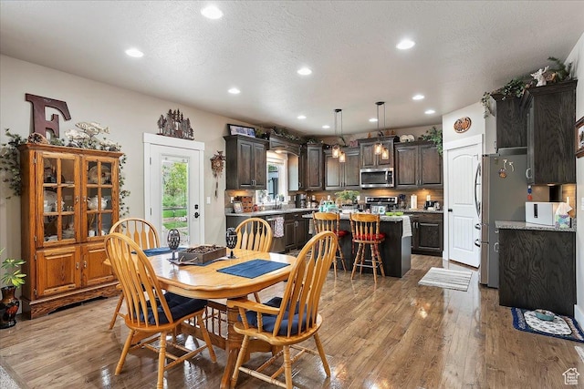4548 N Sheep Creek Dr, Eden, UT 84310 - dining room featuring light wood-style floors, recessed lighting, and a textured ceiling