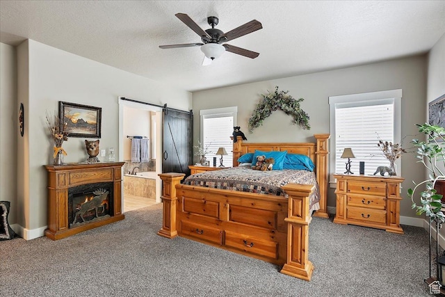 4548 N Sheep Creek Dr, Eden, UT 84310 - bedroom with carpet, ensuite bath, ceiling fan, a barn door, and a textured ceiling