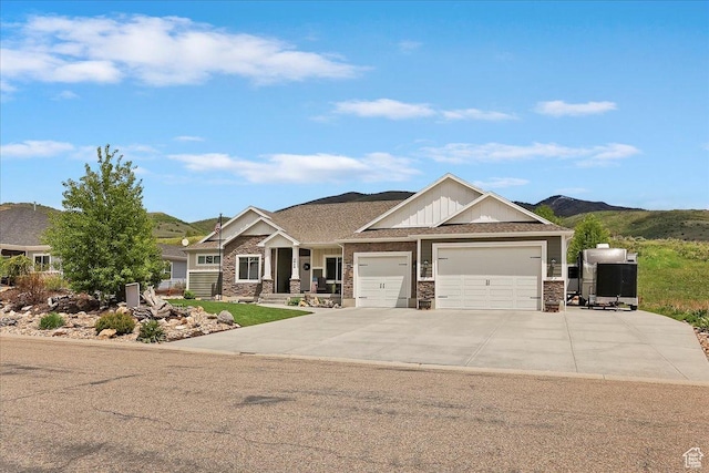 4548 N Sheep Creek Dr, Eden, UT 84310 - craftsman house with a garage, driveway, a mountain view, and stone siding