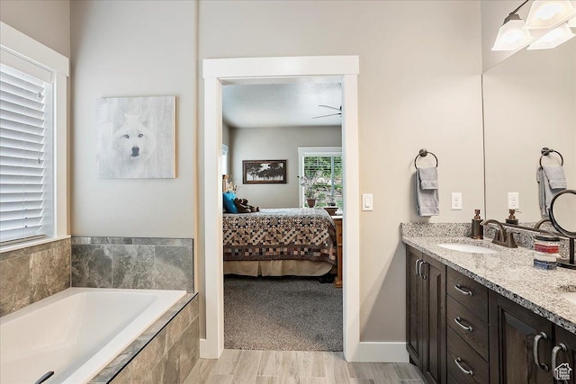 4548 N Sheep Creek Dr, Eden, UT 84310 - ensuite bathroom featuring a garden tub, double vanity, ceiling fan, and wood finished floors