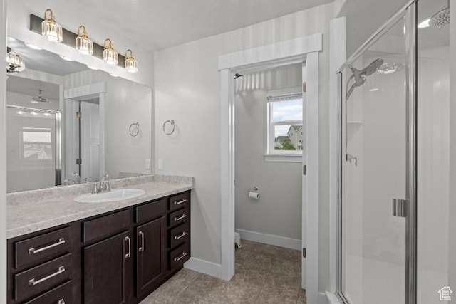 1407 W Fort Rock Dr, Saratoga Springs, UT 84045 - bathroom with a shower stall, vanity, tile patterned floors, baseboards, and toilet