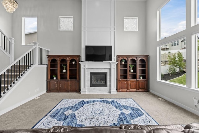 1407 W Fort Rock Dr, Saratoga Springs, UT 84045 - unfurnished living room with carpet flooring, a towering ceiling, plenty of natural light, and stairs