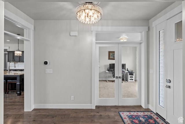 1407 W Fort Rock Dr, Saratoga Springs, UT 84045 - foyer entrance with a chandelier, dark wood-style flooring, french doors, and baseboards