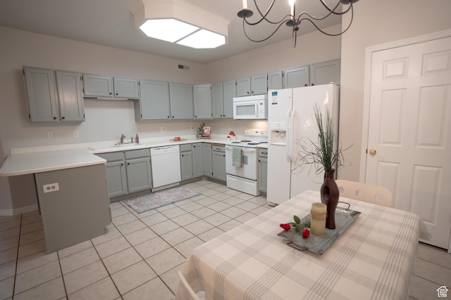 509 N Belmont Pl E Unit 171, Provo, UT 84606 - kitchen featuring white appliances, light tile patterned floors, gray cabinetry, light countertops, and a chandelier