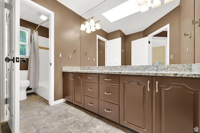 6782 S Courtland Ave, Cottonwood Heights, UT 84121 - full bathroom with double vanity, toilet, shower / bathtub combination with curtain, a skylight, and baseboards