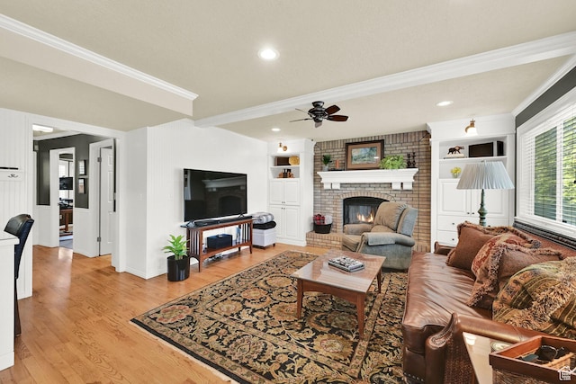 6782 S Courtland Ave, Cottonwood Heights, UT 84121 - living room with a fireplace, crown molding, ceiling fan, light wood finished floors, and baseboards
