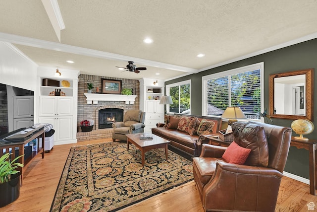 6782 S Courtland Ave, Cottonwood Heights, UT 84121 - living room with ornamental molding, a fireplace, a textured ceiling, a ceiling fan, and light wood-type flooring