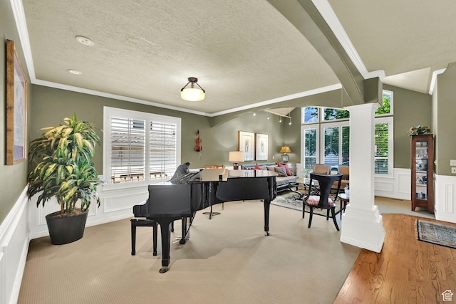 6782 S Courtland Ave, Cottonwood Heights, UT 84121 - sitting room featuring decorative columns, a decorative wall, ornamental molding, a textured ceiling, and wood finished floors