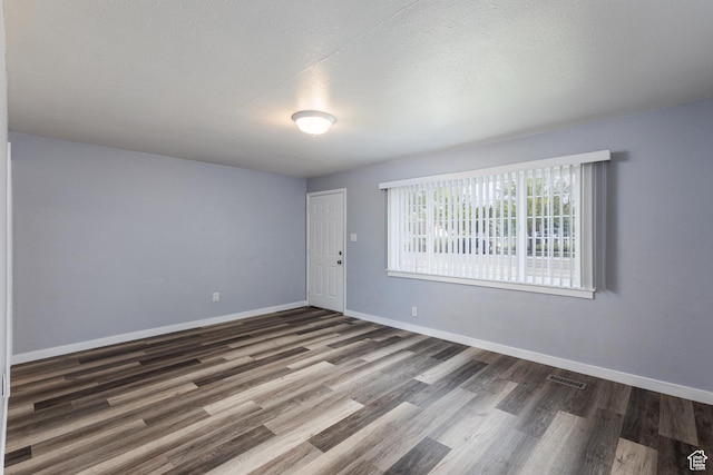 1006 E 300 N, Provo, UT 84606 - unfurnished room with wood finished floors, baseboards, and a textured ceiling