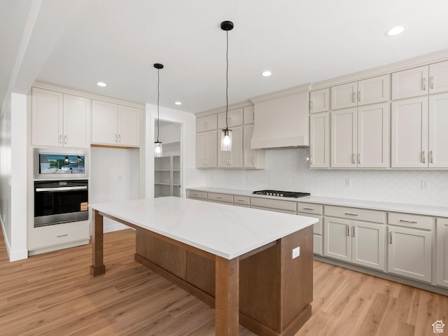 1002 E 400 N Unit 3, Salem, UT 84653 - kitchen with oven, stovetop, custom exhaust hood, stainless steel microwave, and light wood finished floors