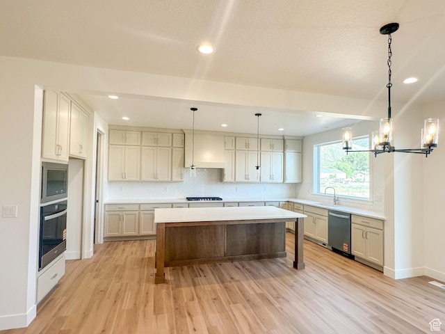 1002 E 400 N Unit 3, Salem, UT 84653 - kitchen with stainless steel appliances, light wood-style flooring, backsplash, a kitchen island, and recessed lighting