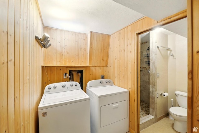 425 E 1200 N, Logan, UT 84341 - laundry area with wooden walls, washer and clothes dryer, and light tile patterned floors
