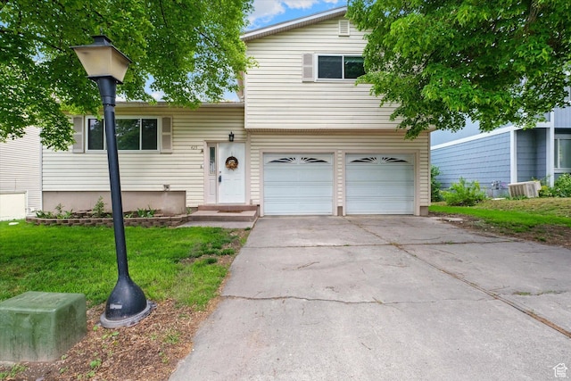 425 E 1200 N, Logan, UT 84341 - tri-level home featuring a garage, a front yard, and concrete driveway