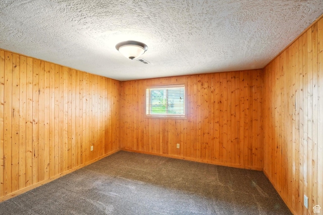 425 E 1200 N, Logan, UT 84341 - unfurnished room featuring carpet flooring, wood walls, and a textured ceiling
