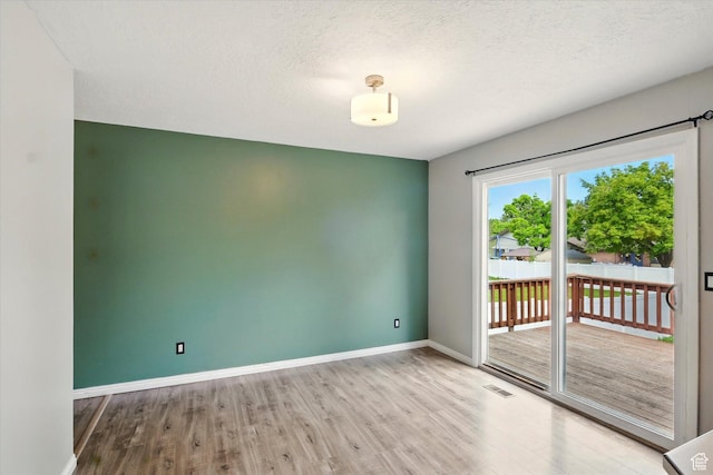 425 E 1200 N, Logan, UT 84341 - unfurnished room with wood finished floors, baseboards, and a textured ceiling