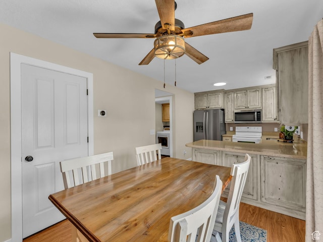 5472 Ardennes Way, Stansbury Park, UT 84074 - dining space with washer / dryer, ceiling fan, and light wood-style flooring