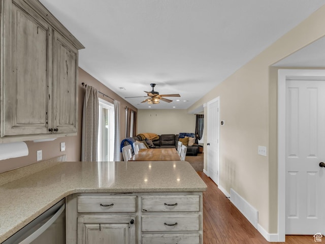 5472 Ardennes Way, Stansbury Park, UT 84074 - kitchen featuring a peninsula, a ceiling fan, wood finished floors, open floor plan, and dishwasher