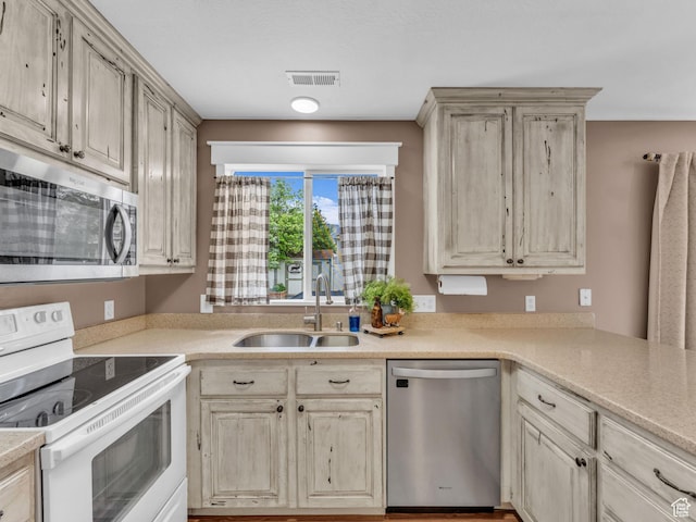 5472 Ardennes Way, Stansbury Park, UT 84074 - kitchen featuring stainless steel appliances, a sink, and light countertops