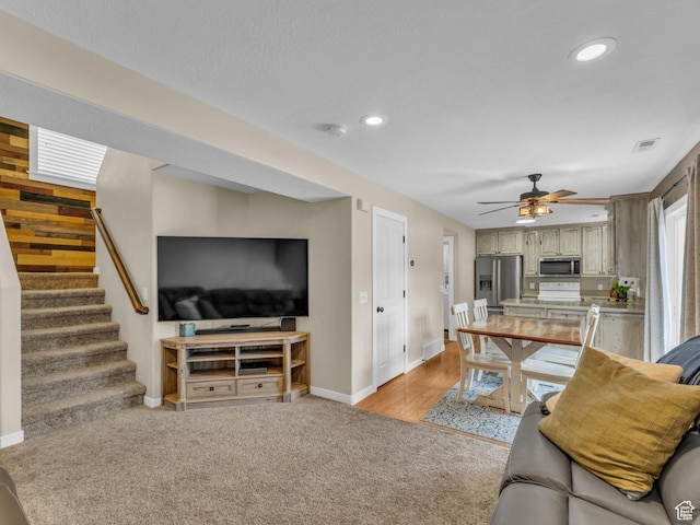 5472 Ardennes Way, Stansbury Park, UT 84074 - living room with baseboards, light colored carpet, stairway, ceiling fan, and recessed lighting
