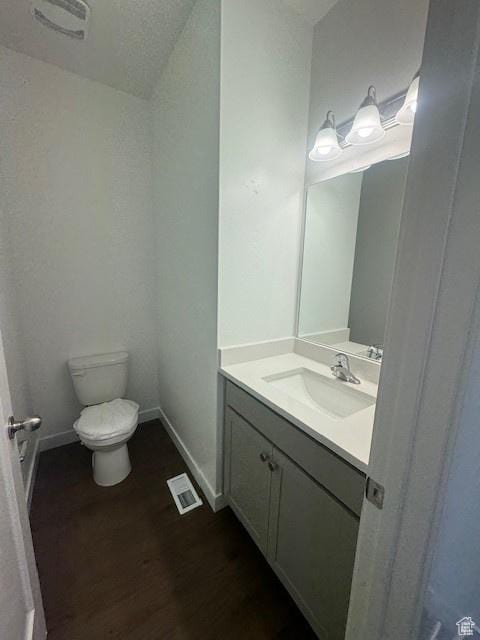 436 W Sapphire Dr Unit 7013, Tooele, UT 84074 - bathroom with toilet, vanity, wood finished floors, and baseboards