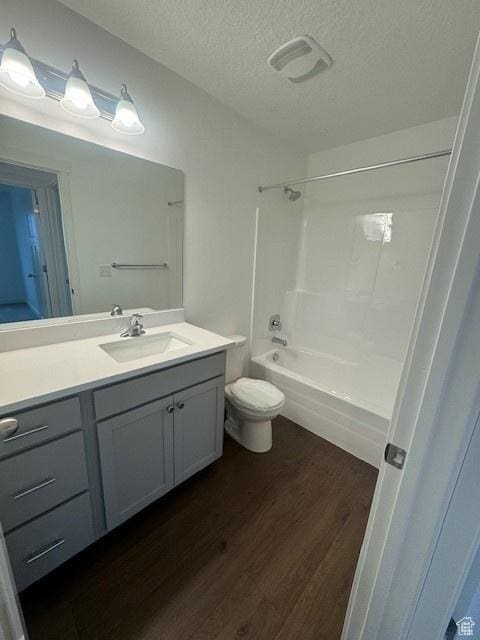 436 W Sapphire Dr Unit 7013, Tooele, UT 84074 - bathroom featuring wood finished floors, vanity, a textured ceiling, shower / bathtub combination, and toilet