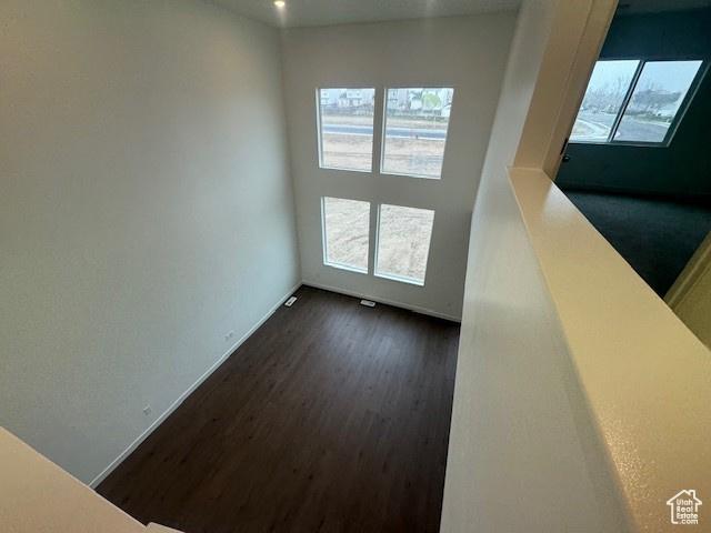 436 W Sapphire Dr Unit 7013, Tooele, UT 84074 - unfurnished room featuring healthy amount of natural light, dark wood-style flooring, and baseboards