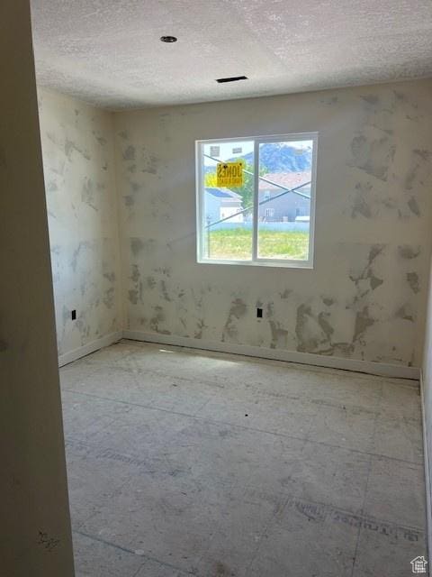 436 W Sapphire Dr Unit 7013, Tooele, UT 84074 - empty room featuring a textured ceiling and baseboards