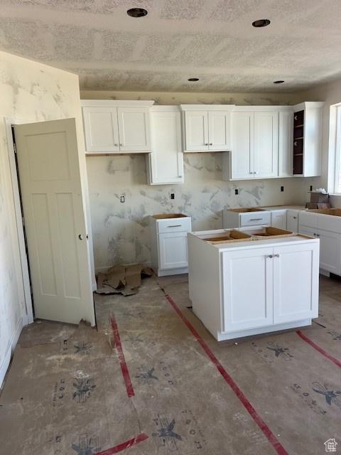 436 W Sapphire Dr Unit 7013, Tooele, UT 84074 - kitchen featuring a kitchen island and white cabinetry