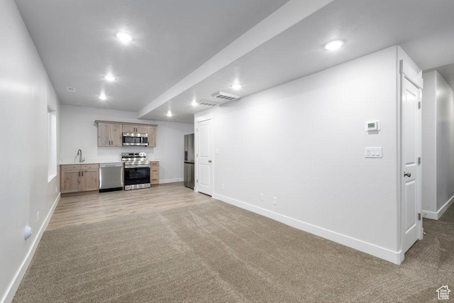 7936 N Bristlecone Rd, Eagle Mountain, UT 84005 - unfurnished living room featuring baseboards, a sink, light carpet, and recessed lighting
